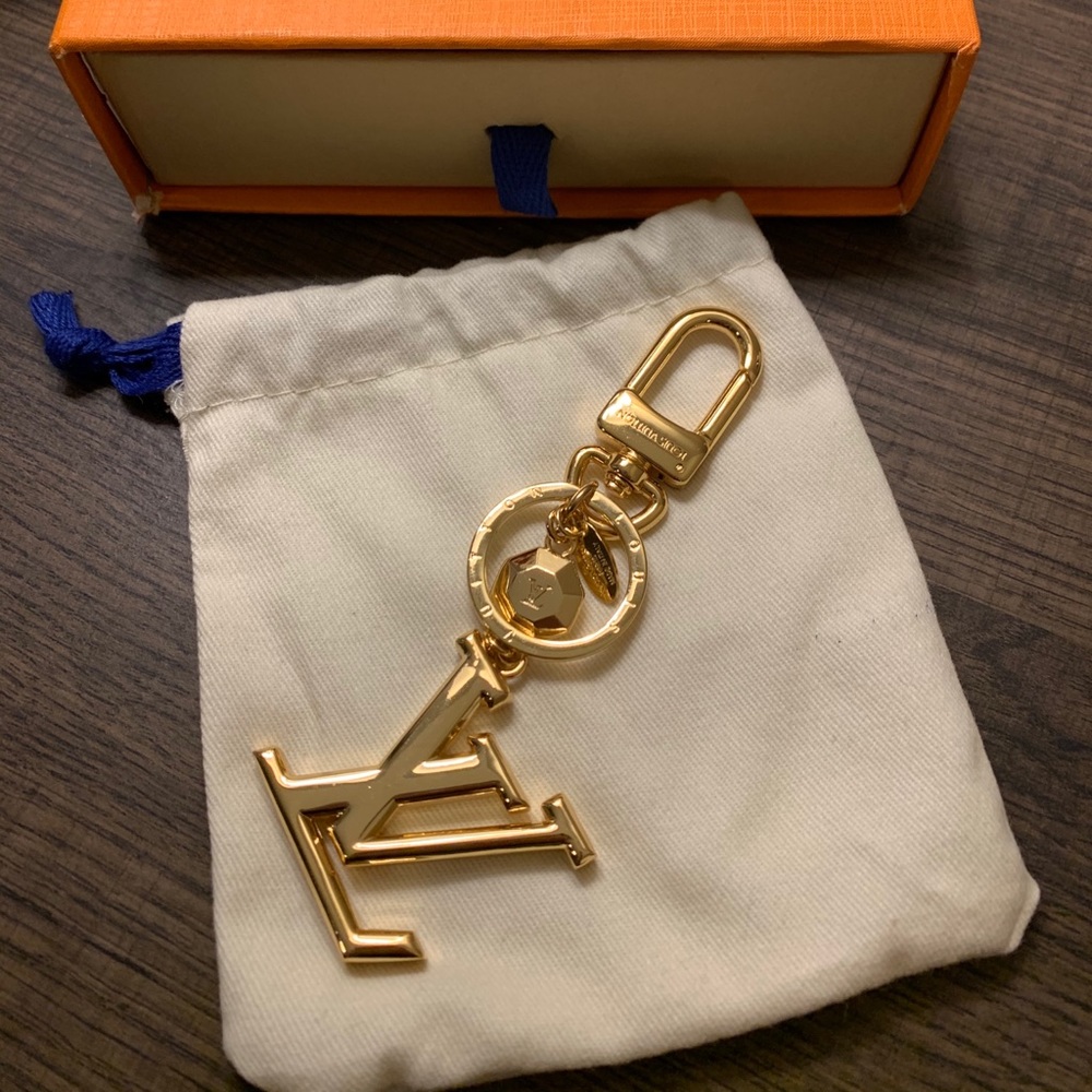 Gold LV bag or key chain.